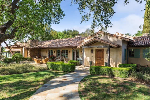 3325 Figueroa Mountain Rd, Los Olivos, CA 93460 - view of front facade featuring stucco siding, a tile roof, and a front lawn