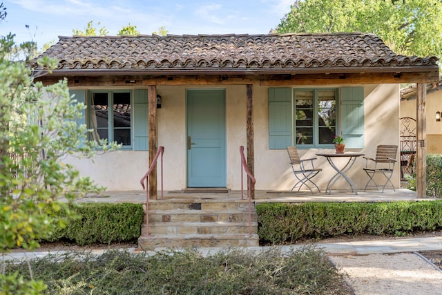 3325 Figueroa Mountain Rd, Los Olivos, CA 93460 - view of front facade featuring covered porch, a tiled roof, and stucco siding