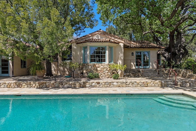 3325 Figueroa Mountain Rd, Los Olivos, CA 93460 - rear view of house featuring a patio, stucco siding, an outdoor pool, and a tile roof