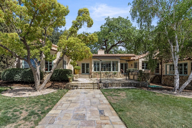 3325 Figueroa Mountain Rd, Los Olivos, CA 93460 - rear view of house featuring a chimney, stucco siding, a lawn, area for grilling, and a tiled roof