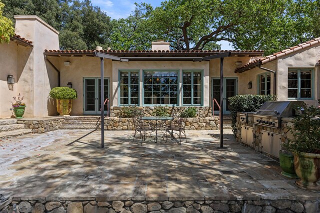 3325 Figueroa Mountain Rd, Los Olivos, CA 93460 - rear view of property featuring french doors, a chimney, a patio, exterior kitchen, and stucco siding