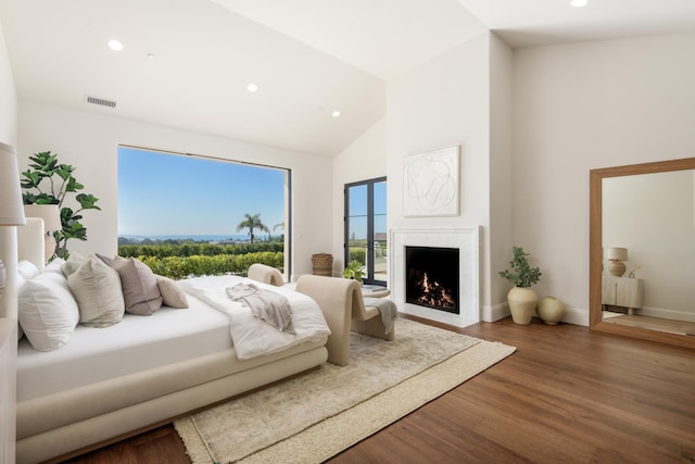 bedroom featuring recessed lighting, a fireplace with flush hearth, visible vents, and wood finished floors