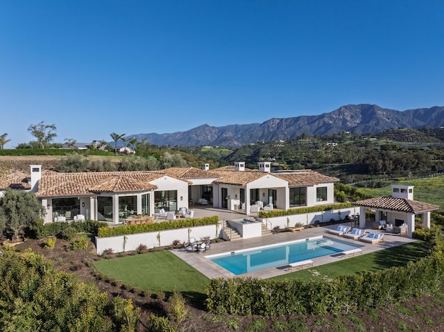 back of house with a patio, stucco siding, outdoor lounge area, and a mountain view
