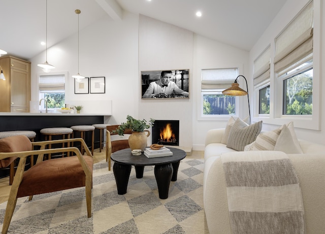 23 Calaveras Ave, Goleta, CA 93117 - living room featuring beamed ceiling, a lit fireplace, recessed lighting, and plenty of natural light