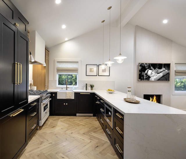 23 Calaveras Ave, Goleta, CA 93117 - kitchen featuring a sink, a peninsula, light stone countertops, high end stainless steel range oven, and dark cabinetry