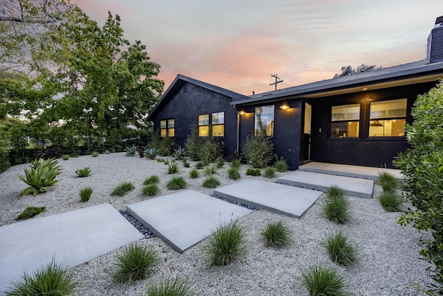 23 Calaveras Ave, Goleta, CA 93117 - back of house at dusk featuring stucco siding and a patio