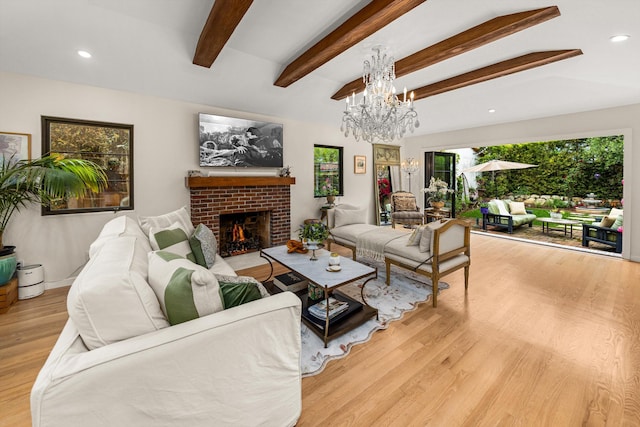 305 E Islay St, Santa Barbara, CA 93101 - living room with beam ceiling, wood finished floors, recessed lighting, an inviting chandelier, and a brick fireplace