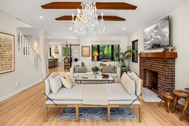 305 E Islay St, Santa Barbara, CA 93101 - living area with an inviting chandelier, stairway, wood finished floors, and a fireplace