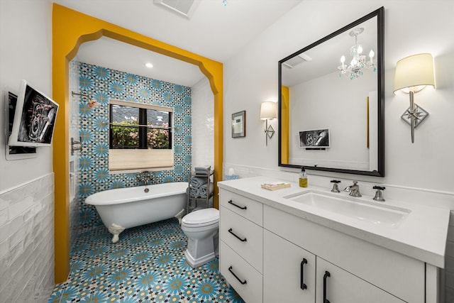 305 E Islay St, Santa Barbara, CA 93101 - bathroom with tile walls, vanity, visible vents, wainscoting, and a freestanding bath