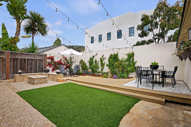910 N Nopal St, Santa Barbara, CA 93103 - view of yard featuring a deck, a fire pit, outdoor dining area, and a patio