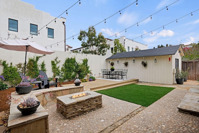 910 N Nopal St, Santa Barbara, CA 93103 - view of yard featuring an outdoor fire pit, a patio area, outdoor dining space, and an outdoor structure