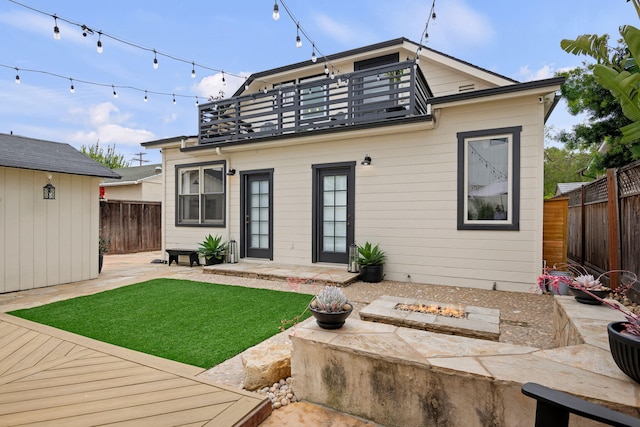 910 N Nopal St, Santa Barbara, CA 93103 - rear view of house featuring a balcony, an outdoor fire pit, a patio, and an outbuilding