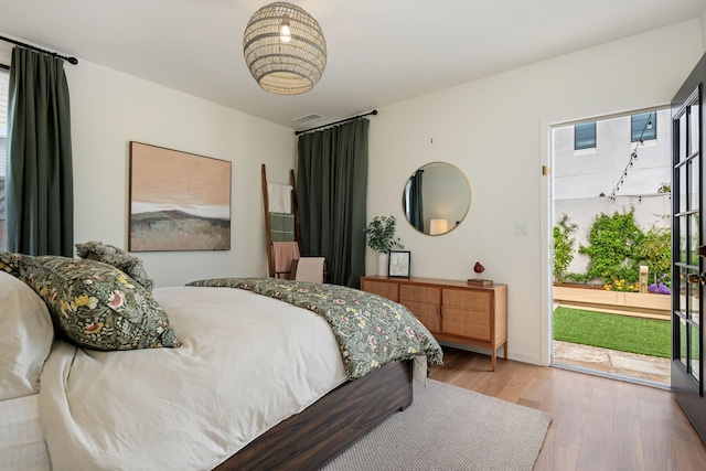 910 N Nopal St, Santa Barbara, CA 93103 - bedroom with access to exterior, wood finished floors, and multiple windows