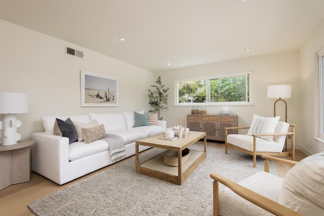 living area featuring light wood-type flooring and recessed lighting