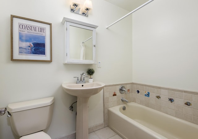 bathroom with a bath, toilet, and tile patterned flooring