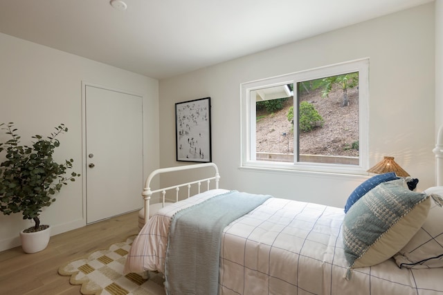 bedroom featuring wood finished floors and baseboards