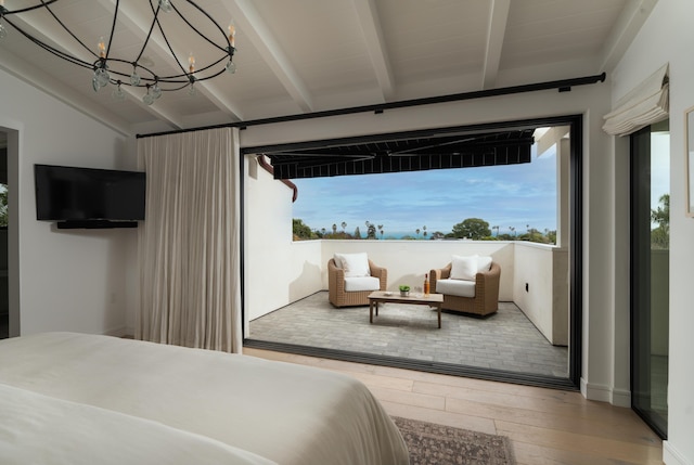 bedroom with a chandelier, hardwood / wood-style floors, and vaulted ceiling with beams