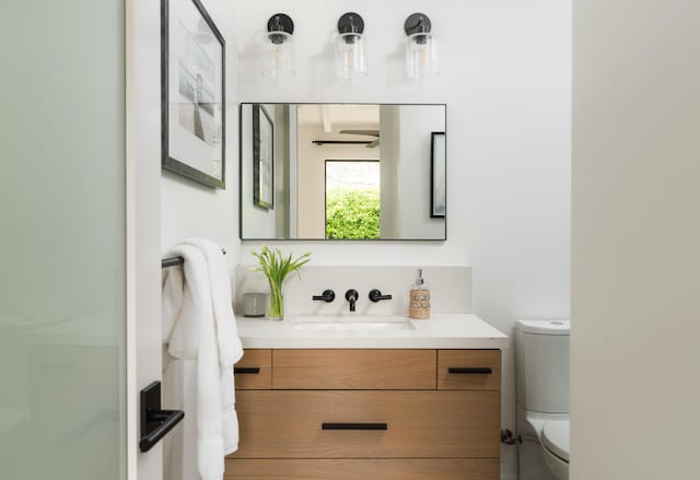 bathroom featuring vanity and toilet