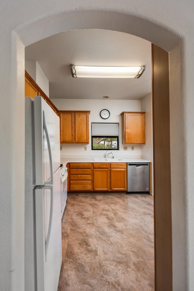 4643 Gerona Way, Santa Barbara, CA 93110 - kitchen with white appliances, a sink, light countertops, and brown cabinetry