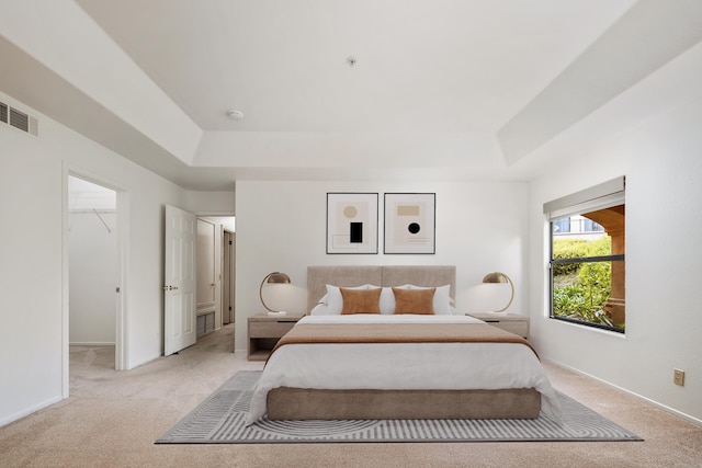 4643 Gerona Way, Santa Barbara, CA 93110 - bedroom featuring a tray ceiling, light carpet, a walk in closet, and baseboards