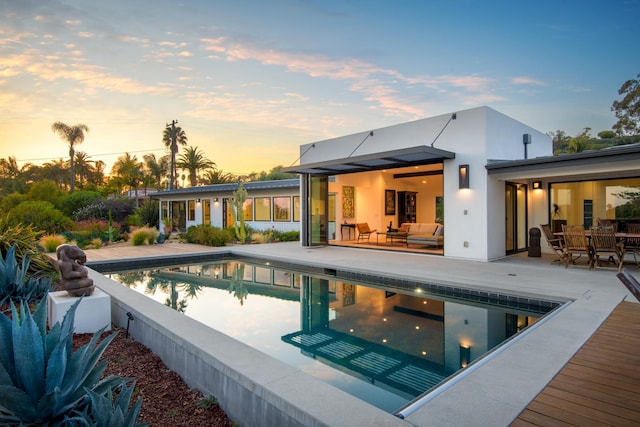 415 Yankee Farm Rd, Santa Barbara, CA 93109 - pool at dusk featuring an outdoor pool, a patio area, an outdoor living space, and outdoor dining space