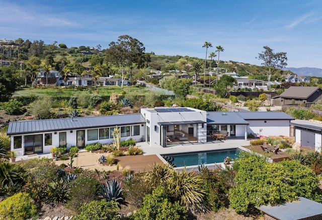 415 Yankee Farm Rd, Santa Barbara, CA 93109 - back of property featuring a residential view, a patio, an outdoor pool, and metal roof