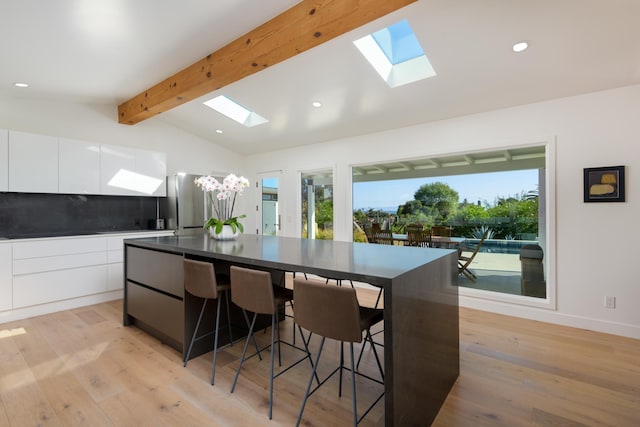 415 Yankee Farm Rd, Santa Barbara, CA 93109 - kitchen with a skylight, modern cabinets, dark countertops, and recessed lighting