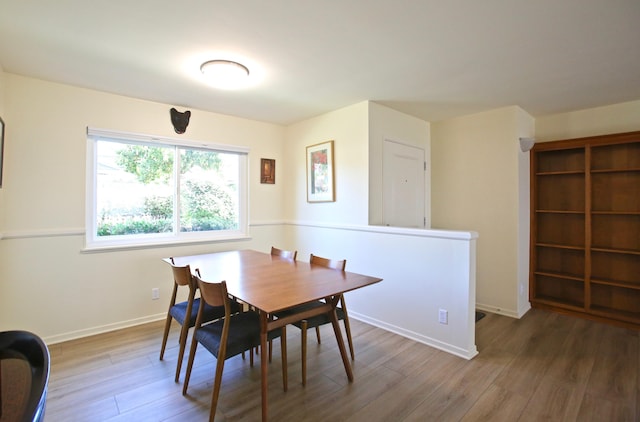 dining room featuring wood finished floors and baseboards