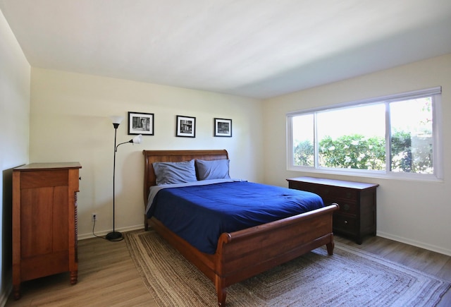 bedroom with light wood-style floors and baseboards