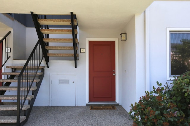doorway to property with stucco siding