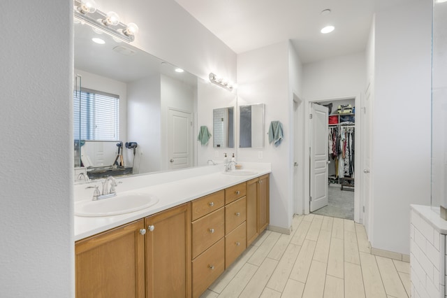1010 Tranquillion Ct, Lompoc, CA 93436 - bathroom with double vanity, wood finished floors, a spacious closet, and recessed lighting