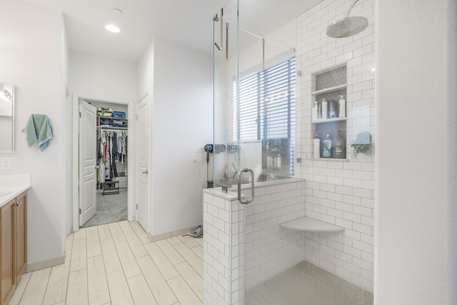 1010 Tranquillion Ct, Lompoc, CA 93436 - full bath featuring vanity, a stall shower, a walk in closet, wood finished floors, and baseboards