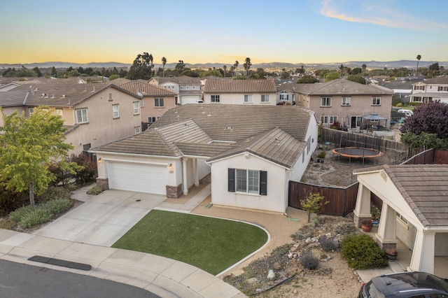 1010 Tranquillion Ct, Lompoc, CA 93436 - view of front of home featuring a residential view, a tiled roof, an attached garage, a fenced backyard, and concrete driveway