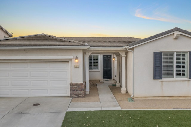 1010 Tranquillion Ct, Lompoc, CA 93436 - ranch-style home with concrete driveway, an attached garage, a tiled roof, and stucco siding