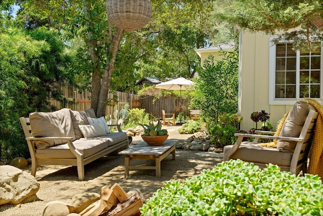 view of patio featuring an outdoor living space and fence