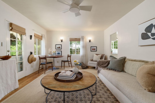 living room featuring healthy amount of natural light, wood finished floors, and ceiling fan