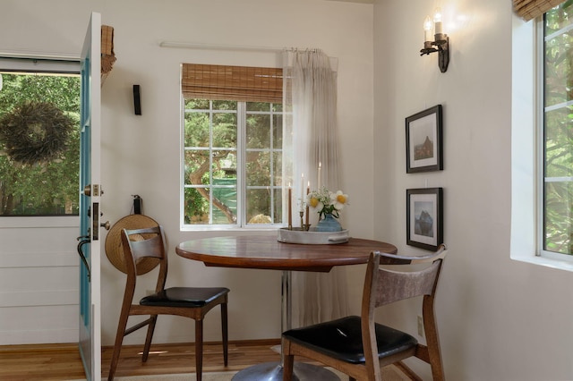 dining space with wood finished floors and baseboards