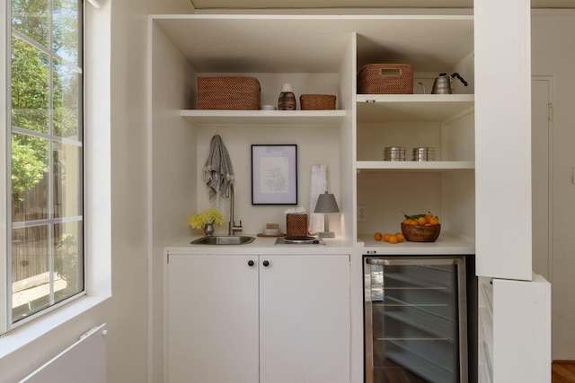 indoor wet bar featuring beverage cooler
