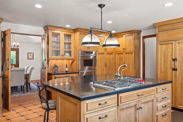10971 Alto Ct, Oak View, CA 93022 - kitchen featuring appliances with stainless steel finishes, dark countertops, a chandelier, recessed lighting, and an island with sink