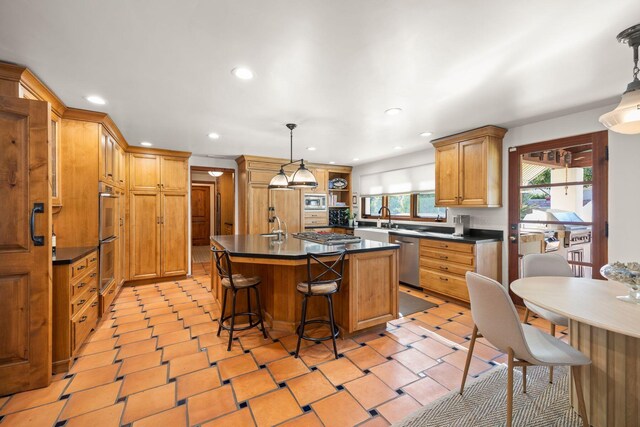 10971 Alto Ct, Oak View, CA 93022 - kitchen with dark countertops, stainless steel appliances, a sink, a kitchen island, and recessed lighting