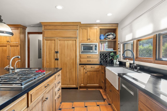 10971 Alto Ct, Oak View, CA 93022 - kitchen featuring appliances with stainless steel finishes, dark countertops, a sink, recessed lighting, and brown cabinetry
