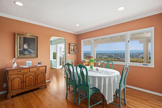 170 Loma Media Rd, Santa Barbara, CA 93103 - dining space with arched walkways, light wood finished floors, crown molding, and recessed lighting