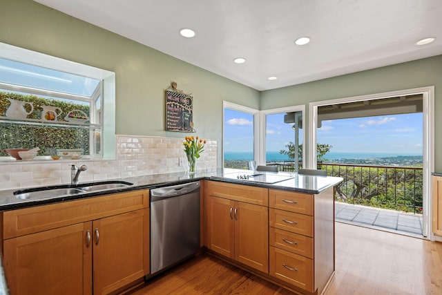170 Loma Media Rd, Santa Barbara, CA 93103 - kitchen with dishwasher, brown cabinetry, a peninsula, light wood-style floors, and dark stone countertops