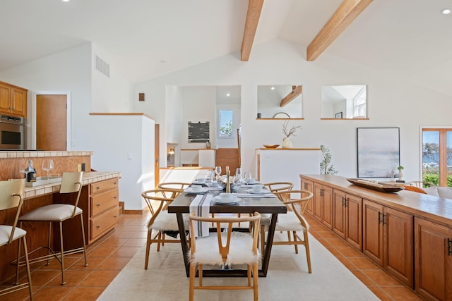 5529 Calle Arena, Carpinteria, CA 93013 - dining room with light tile patterned floors, beamed ceiling, and high vaulted ceiling