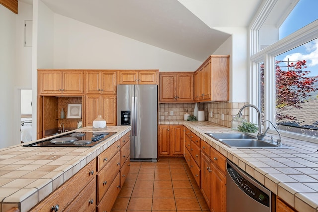 5529 Calle Arena, Carpinteria, CA 93013 - kitchen with appliances with stainless steel finishes, tile counters, a sink, tasteful backsplash, and light tile patterned flooring