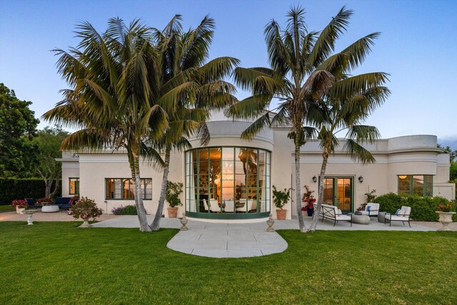 7200 Casitas Pass Rd, Carpinteria, CA 93103 - rear view of property with an outdoor living space, a patio area, a lawn, and stucco siding