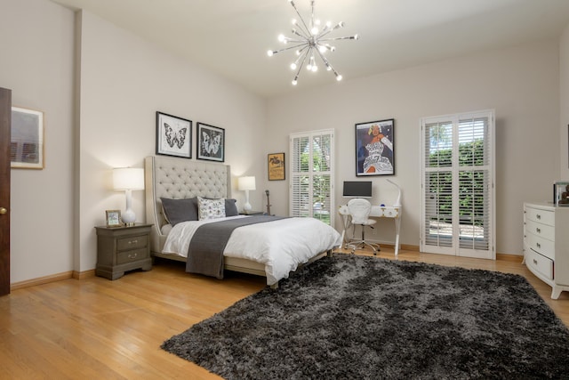 7200 Casitas Pass Rd, Carpinteria, CA 93103 - bedroom featuring a chandelier, light wood-type flooring, and baseboards