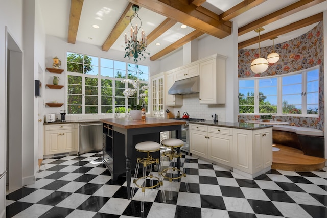 7200 Casitas Pass Rd, Carpinteria, CA 93103 - kitchen featuring under cabinet range hood, a chandelier, stainless steel appliances, beamed ceiling, and open shelves