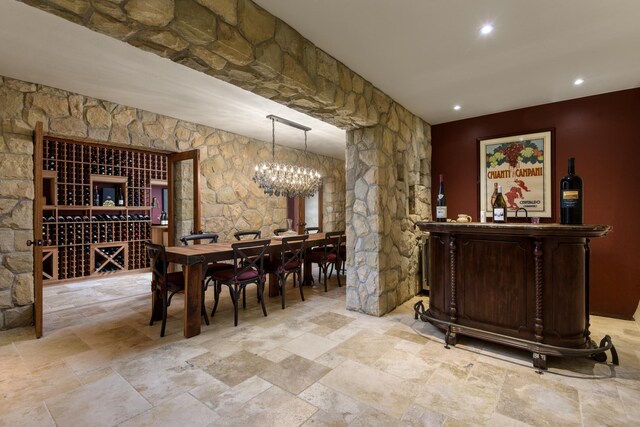 7200 Casitas Pass Rd, Carpinteria, CA 93103 - bar featuring a chandelier, light stone finish flooring, recessed lighting, and hanging light fixtures