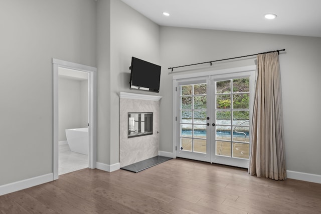 919 Aleeda Ln, Santa Barbara, CA 93108 - unfurnished living room with wood finished floors, french doors, high vaulted ceiling, baseboards, and a high end fireplace